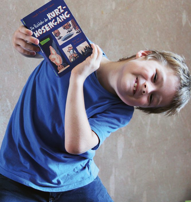 Jakob zeigt sein Lieblingsbuch. Er geht jetzt in die 2. Klasse, bald kann er es selbst lesen. Foto: Dominique Hensel