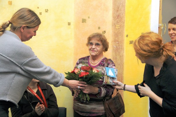 Margot Visser bekommt einen Blumenstrauß vom Team des Quartiersmanagements Brunnenstraße. Foto: Hensel