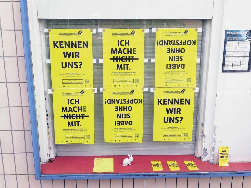 Plakate im Fenster des Quartiersmanagements weisen auf die Kiezwahl 2021 im September hin. Foto: D. Hensel