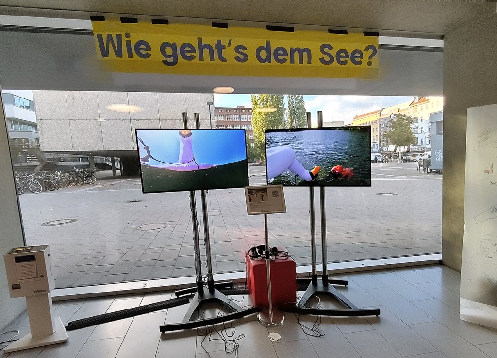 Auf zwei Bildschirme laufen Filme über den Plötzensee